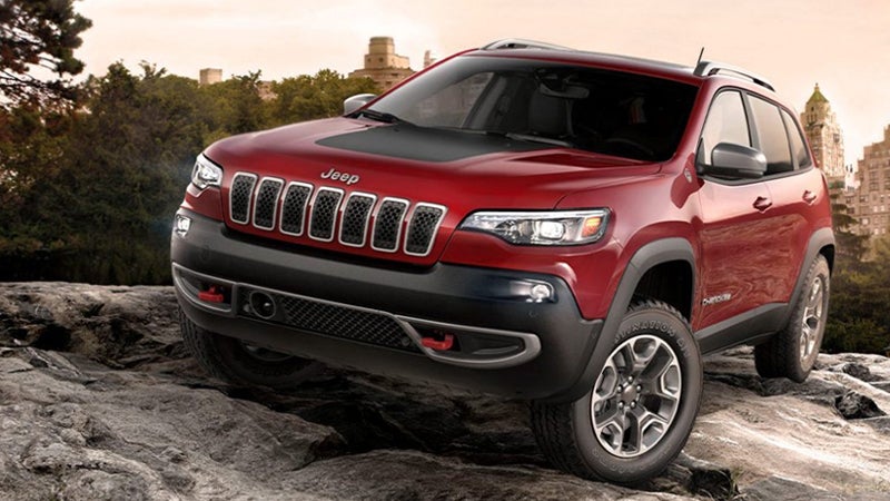 Red Jeep Cherokee SUV on rocky terrain
